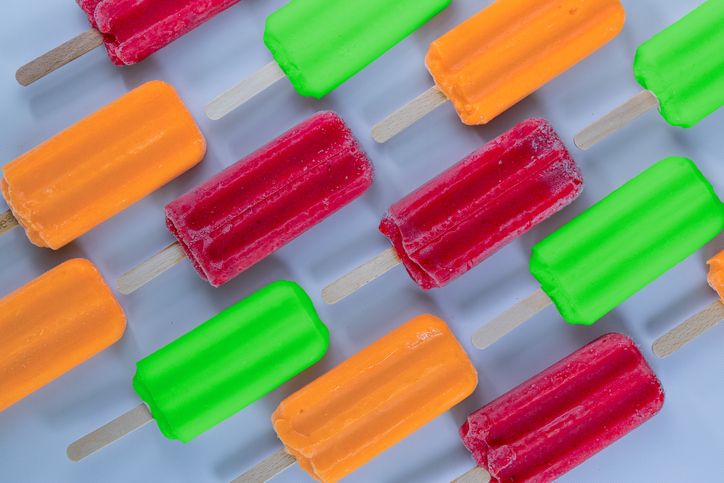 Brightly colored ice pops with wooden sticks