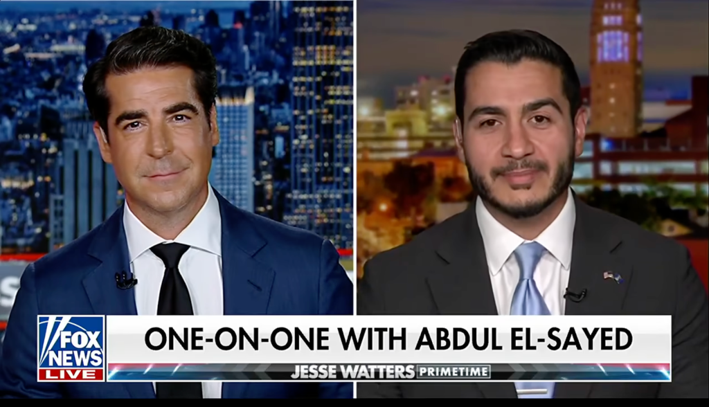 Two news anchors, one from Fox News and one from an unidentified station, engaged in a one-on-one interview titled "ONE-ON-ONE WITH ABDUL EL-SAYED".