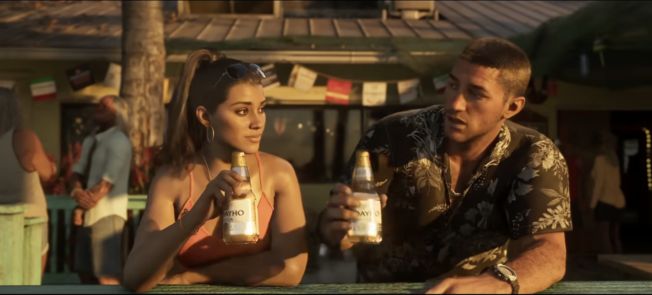Two people holding bottles of Vivo soda in an outdoor setting with a wooden structure in the background.
